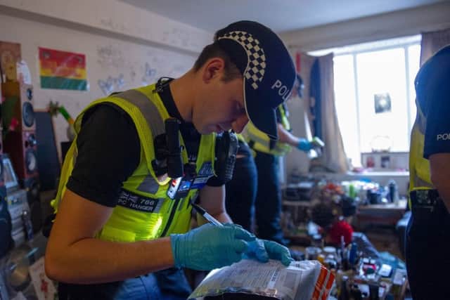Officers searching inside one of the properties in Wellingborough