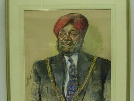 The painting of the late councillor Jaswant Bains has been stolen.