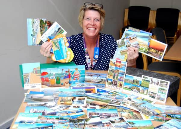 Forget-Me-Not Appeal organiser Jayne Chambers with some of the 140 holiday postcards local people have sent in to support patients living with dementia