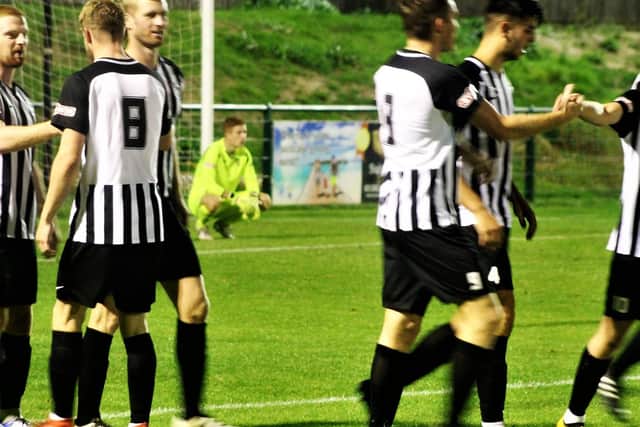 The Corby Town players celebrate Ben Bradshaw's first goal during the 4-0 victory at Dunstable Town in the Emirates FA Cup preliminary round replay. Picture by David Tilley