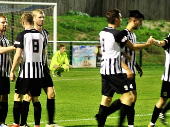 The Corby Town players celebrate Ben Bradshaw's first goal during the 4-0 victory at Dunstable Town in the Emirates FA Cup preliminary round replay. Picture by David Tilley