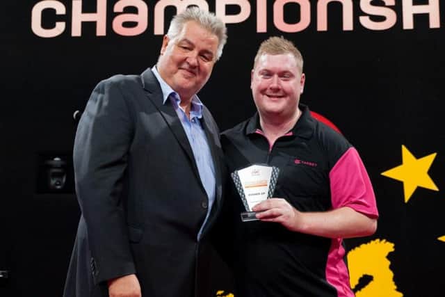 Ricky Evans receives the runners-up trophy at the Dutch Darts Championship. Picture courtesy of PDC