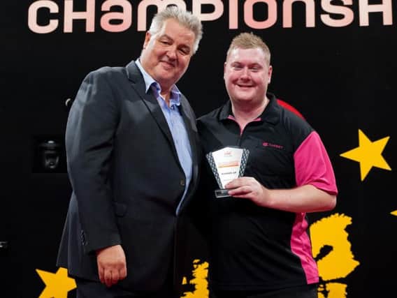 Ricky Evans receives the runners-up trophy at the Dutch Darts Championship. Picture courtesy of PDC