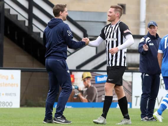 Boss Steve Kinniburgh and striker Elliot Sandy enjoy the moment after Corby Town's FA Cup success over Hertford Town. Picture by Alison Bagley