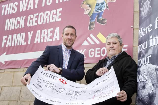 Paul Scully-Sloan (right) is handed the cheque (picture: Kirsty Edmonds)
