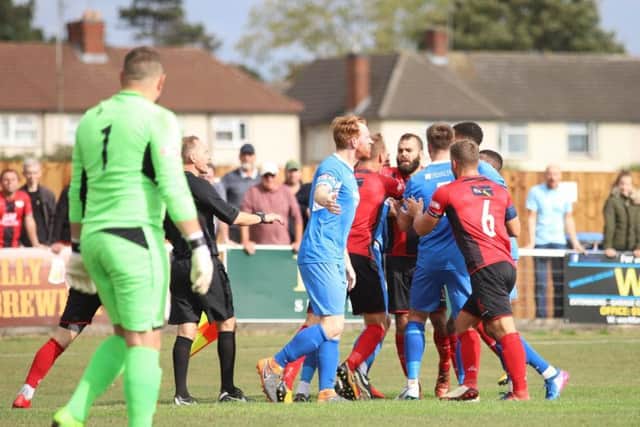 Tempers flare after Kettering Town were awarded a penalty during their 2-1 home defeat to Leiston. Pictures by Peter Short