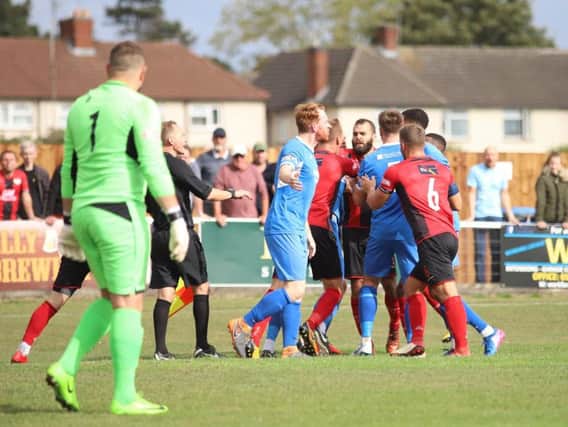 Tempers flare after Kettering Town were awarded a penalty during their 2-1 home defeat to Leiston. Pictures by Peter Short