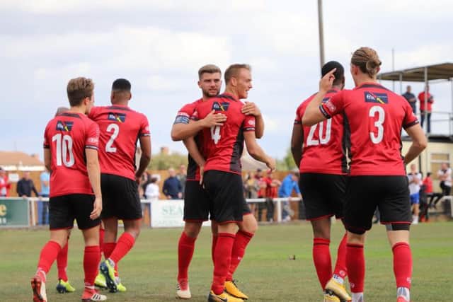 Brett Solkhon takes the congratulations after he brought the Poppies level from the penalty spot