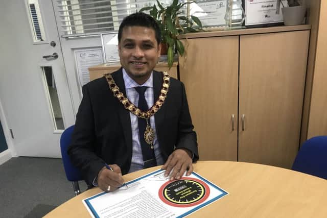 Cllr Rahman signs the pledge. NNL-180920-110556005