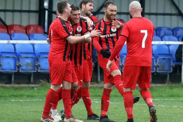 Nathan Heycock takes the congratulations after scoring Irchester United's winning goal in their 4-3 victory over Sileby Rangers. Pictures by Alison Bagley