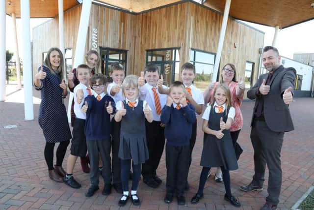 Pupils and headteacher Craig Charteris (right) celebrate the Ofsted grade. NNL-180925-150601005