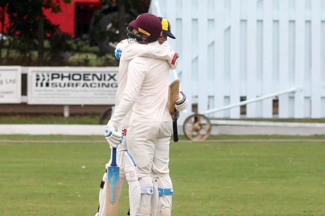 Finedon captain Callum Berrill and Tom Sole celebrate after they reached the 150-run mark to secure the two points they needed to wrap up the Premier Division title