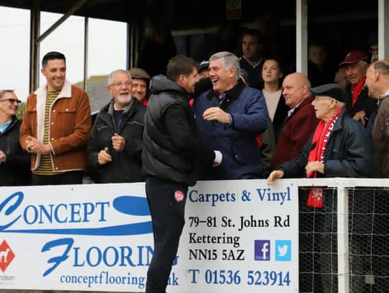 Kettering Town manager Marcus Law shares a joke with club legend and record appearance holder Roger Ashby ahead of last weekend's FA Cup victory over AFC Mansfield. Picture by Peter Short