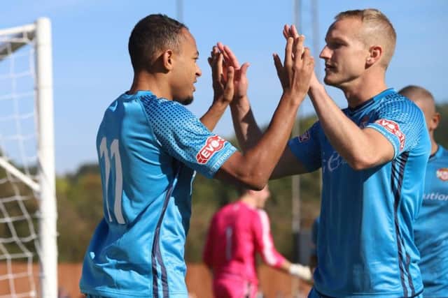 Rhys Hoenes and Marcus Kelly celebrate after the former had opened the scoring from the penalty spot