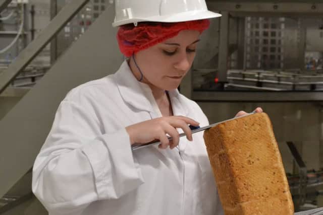 Production technologist Lauren Jokl checking bread spec. NNL-180210-131435005