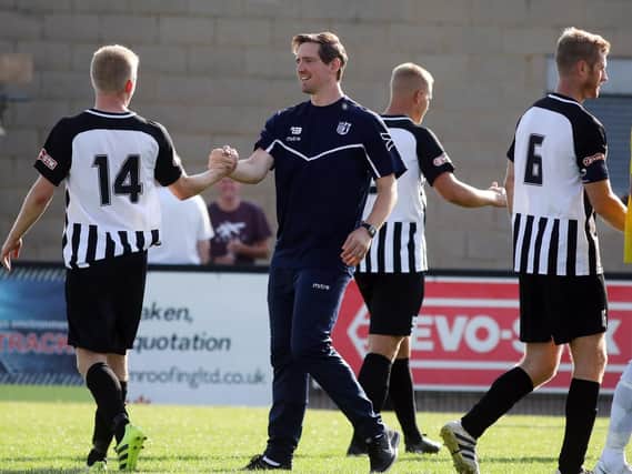 Steve Kinniburgh and his Corby Town players are eyeing an FA Cup upset at Stockport County this weekend