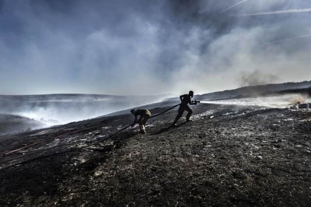File photo dated 28/6/2018 of firefighters tackle the wildfire on Saddleworth Moor. Firefighters have warned they are under-funded, short-staffed and ill-equipped to deal with an increase in wildfires as new figures show the number of blazes on open ground this summer was more than double the average of previous years. pa/FIRE Summer 07063235.JPG