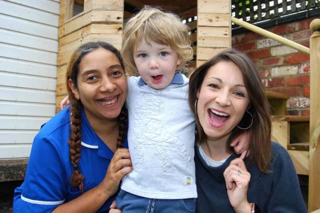 Midwife Serena Smith with Jasper, two, and mum Kelly
