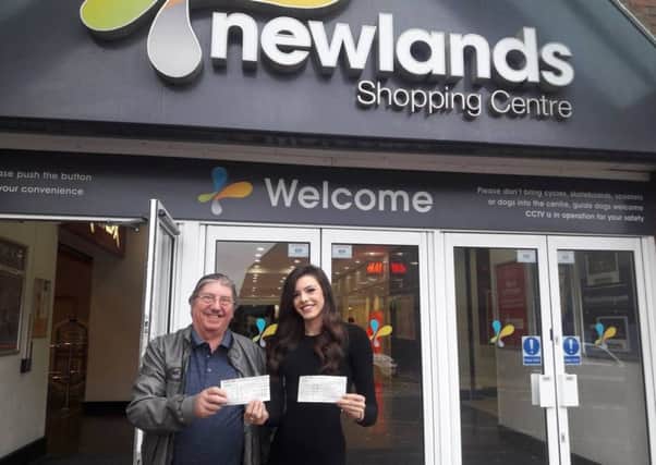 John Cecil with Newlands Shopping Centre's marketing manager Jodie Lockley with the cheque's. NNL-181210-140010005