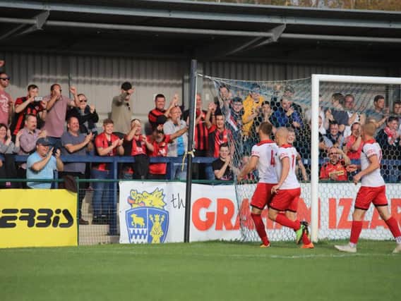 Brett Solkhon celebrates in front of the travelling Kettering Town fans after his penalty gave them the lead in their 3-0 win at St Neots Town. Picture by Peter Short