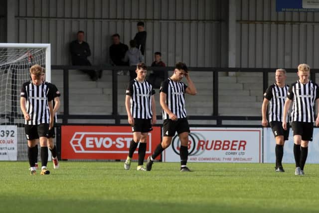 The Corby Town players show their dejection after conceding in their 3-2 home loss to Yaxley in the preliminary round of the FA Trophy. Picture by Alison Bagley