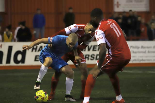 Lindon Meikle is challenged by two Tamworth players