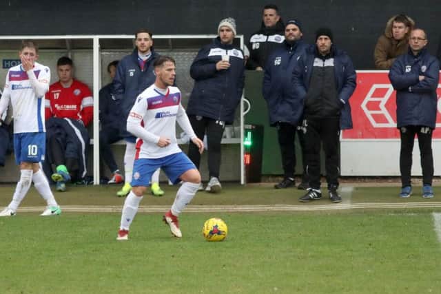 Andy Peaks and the AFC Rushden & Diamonds bench watch on during their 2-1 victory over St Ives Town at Hayden Road. Pictures by Alison Bagley