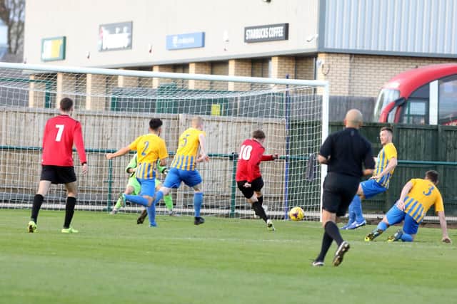 Kieran Turner scores from the penalty spot (left) to put Tring Athletic 2-0 up against Wellingborough Town