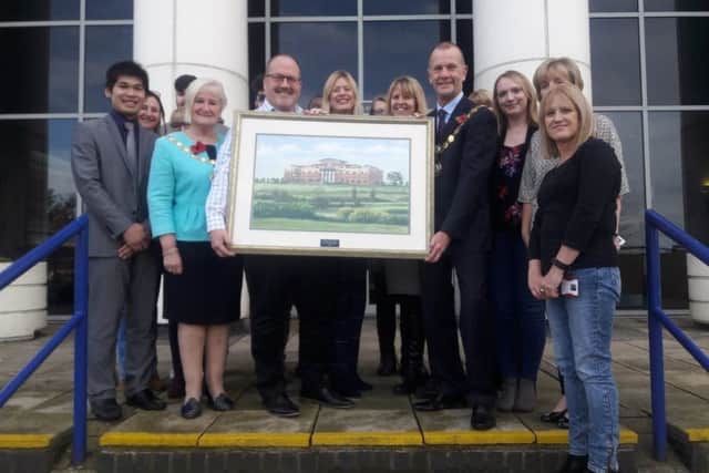 The mayor of Kettering presents the picture to RCI. NNL-180911-114507005
