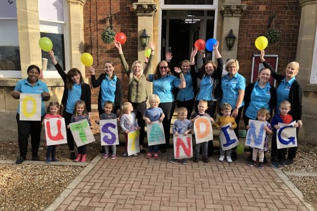 Staff and children at the nursery celebrate the Ofsted grade. NNL-181211-151812005