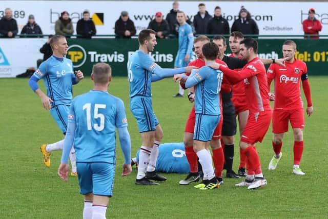 Kettering Town and Stamford players square up after a challenge on Michael Richens during the Poppies' 1-0 defeat last weekend. Picture by Geoff Atton