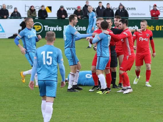 Kettering Town and Stamford players square up after a challenge on Michael Richens during the Poppies' 1-0 defeat last weekend. Picture by Geoff Atton