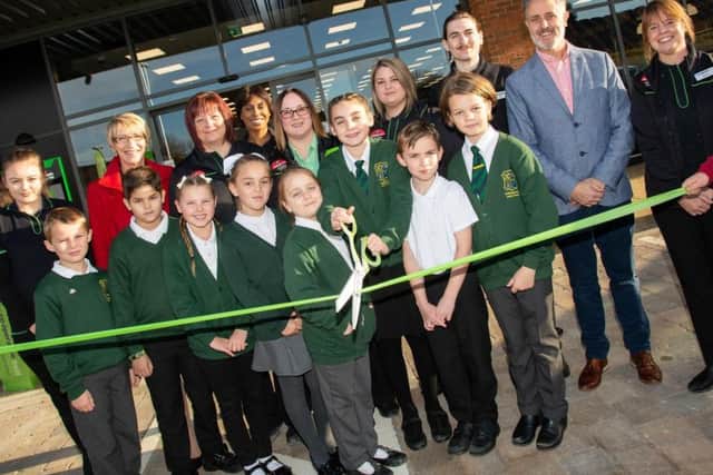 Youngsters from Irthlingborough Junior School and Store Manager Michelle Santoro cut the ribbon to mark the opening of the new Irthlingborough Food Store. NNL-181116-101653005