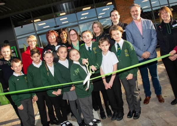 Youngsters from Irthlingborough Junior School and Store Manager Michelle Santoro cut the ribbon to mark the opening of the new Irthlingborough Food Store. NNL-181116-101653005