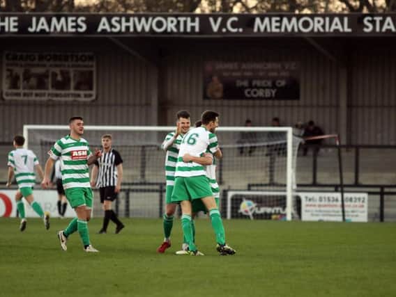 Thame United celebrate one of their three goals as Corby Town slipped to a 3-1 defeat at Steel Park. Pictures by Alison Bagley