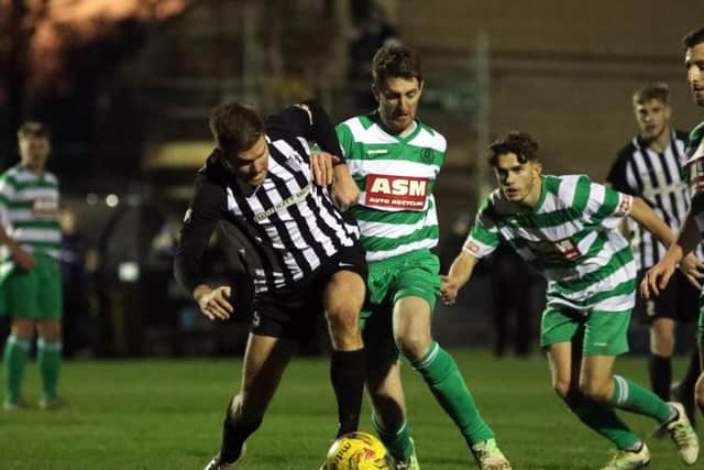 Elliot Sandy battles for possession at Steel Park