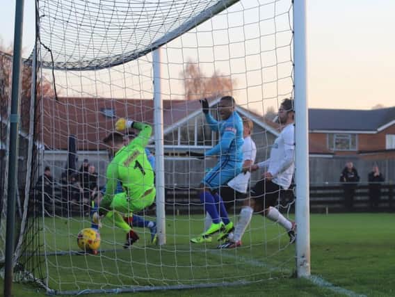 The ball is in the net after Dan Holman grabbed Kettering Town's goal in their fine 1-0 success at Royston Town. Pictures by Peter Short