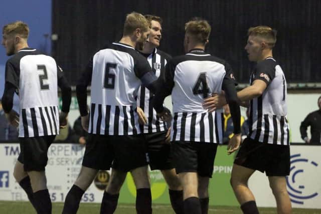 The Corby Town players celebrate Elliot Sandy's second goal, which proved to be the winner in their 3-2 victory over Aylesbury United at Steel Park. Pictures by Alison Bagley