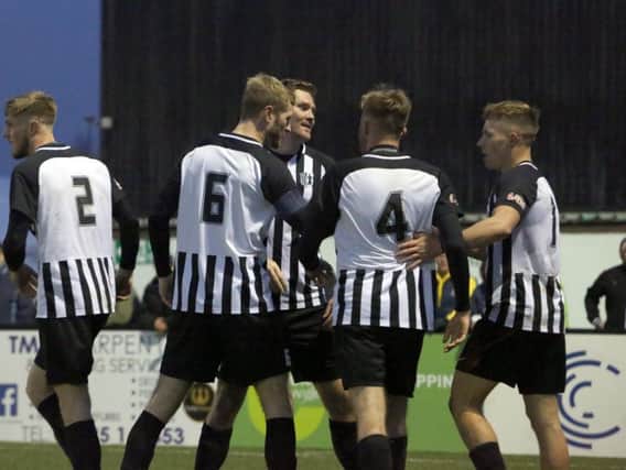 The Corby Town players celebrate Elliot Sandy's second goal, which proved to be the winner in their 3-2 victory over Aylesbury United at Steel Park. Pictures by Alison Bagley