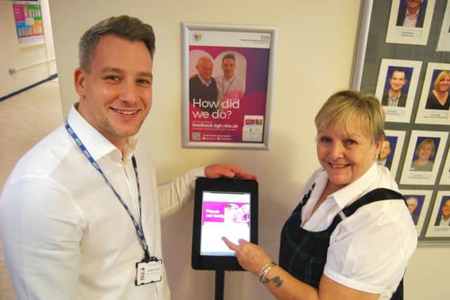Head of Patient Experience and Involvement, James Allan, with Patsy French, from Corby, using one of the new computer pedestals which allow patients, and their families, to feedback on their care at five locations around the hospital site NNL-181129-111315005