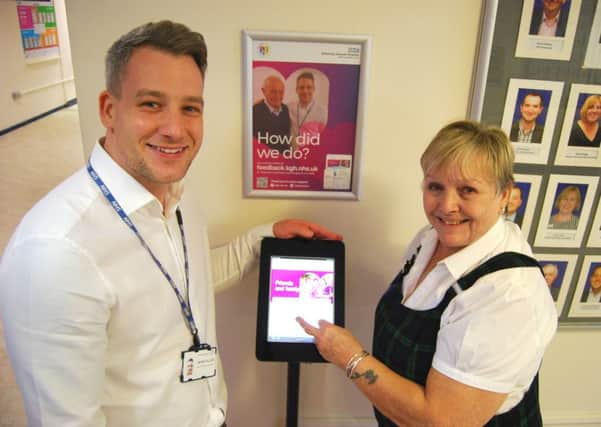 Head of Patient Experience and Involvement, James Allan, with Patsy French, from Corby, using one of the new computer pedestals which allow patients, and their families, to feedback on their care at five locations around the hospital site NNL-181129-111315005