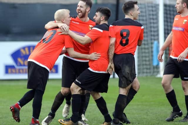 Rushden & Higham United celebrate their opening goal in the 2-0 victory over Thrapston Town in the third round of the NFA Junior Cup. Pictures by Alison Bagley
