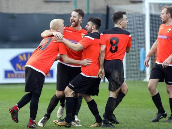 Rushden & Higham United celebrate their opening goal in the 2-0 victory over Thrapston Town in the third round of the NFA Junior Cup. Pictures by Alison Bagley