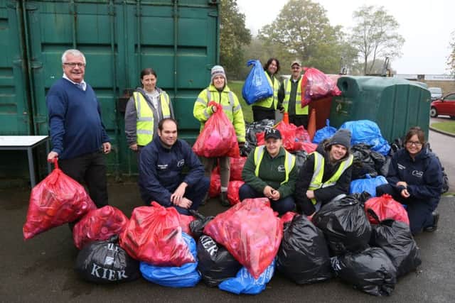 Litter Pick: Corby: The pile of litter collected at Corby Boating Lake
volunteers with neighbourhood wardens and Cllr Mark Pengelly
(far left).