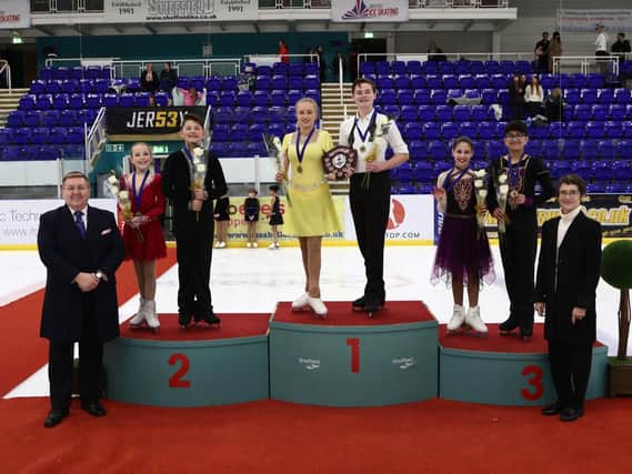 Corbys Stanley Evans and his ice dance partner Olivia Jenkinson stand on the top podium after their success in Sheffield