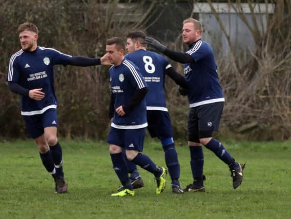 Kettering All Stars celebrate one of Leigh Chapman's three goals during their fine 8-0 success at Great Doddington in Division Four. Pictures by Alison Bagley