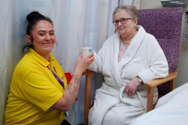 Age UK Northamptonshire Support Worker Jade White gives Marion Frost from Corby a cup of tea
