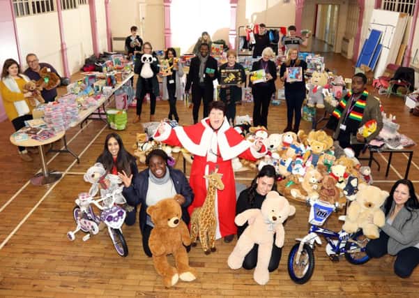 Jeanette Walsh and members of Northamptonshire County Council's social services team with the gifts donated by Northants Telegraph readers
