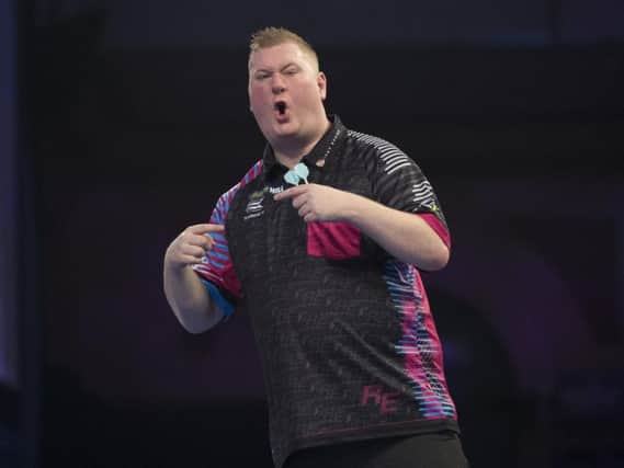 Ketterings Ricky Evans celebrates winning a leg during his first-round match against Rowby-John Rodriguez but Rapid was eventually knocked out of the William Hill World Darts Championship. Picture courtesy of Lawrence Lustig/PDC