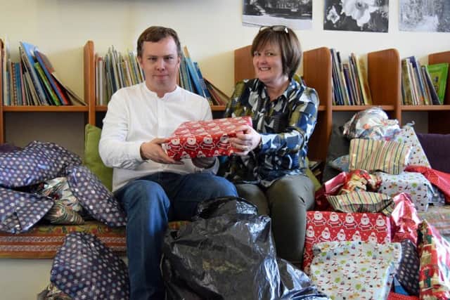 Sharing the Kindness founder Liam Ferguson visits Pen Green in Corby with presents donated by local people who are members of a popular Facebook group. Also picture is Angela Prodger of Pen Green. NNL-181220-142326005